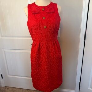 Sandra Darren Coral Red Sleeveless Dress with bow and pattern.
